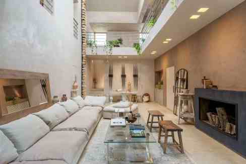 Spacious modern living room with neutral tones and contemporary decor.