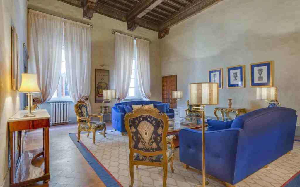 Luxurious living room with blue sofas and antique decor in Florence.