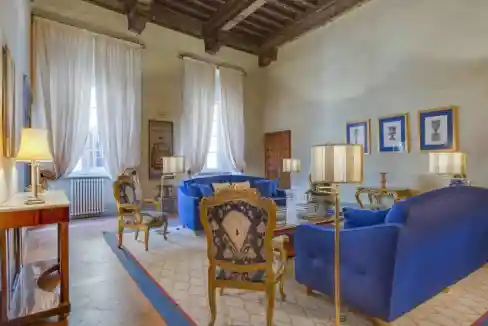 Luxurious living room with blue sofas and antique decor in Florence.
