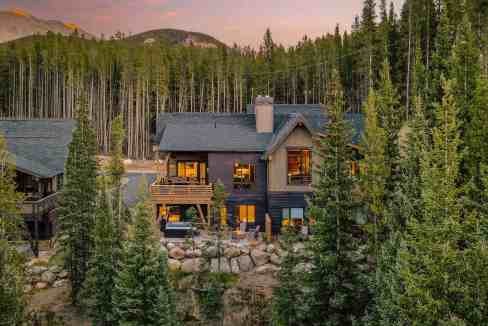Scenic view of Breckenridge Vista Lodge surrounded by pine trees.