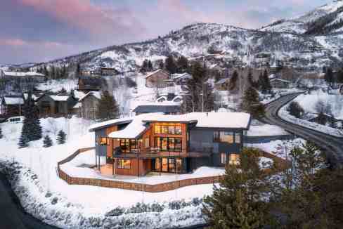Modern mountain home with large windows in snowy Yampa Valley.