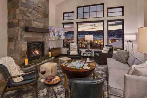 Elegant living room with large windows overlooking mountain landscape.