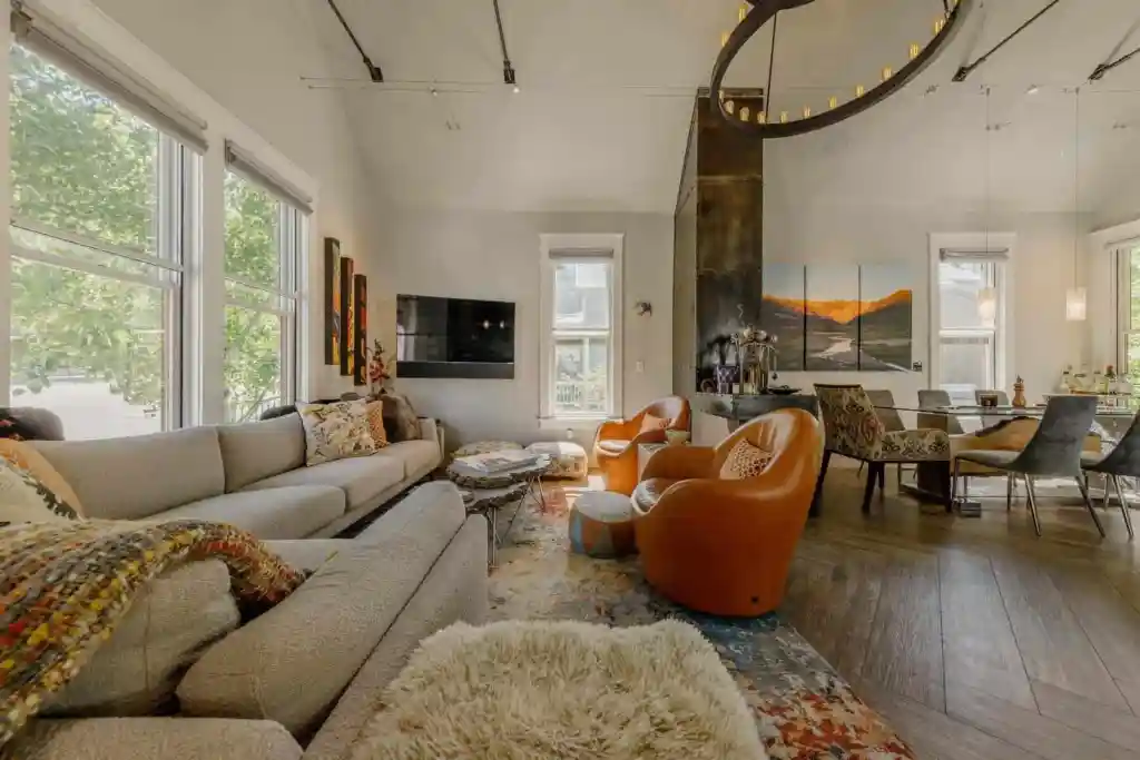 Bright living room with large windows, cozy sofa, and contemporary decor.