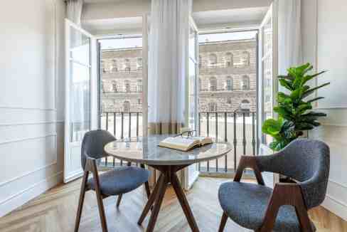Modern apartment with open balcony and cityscape view in Florence.