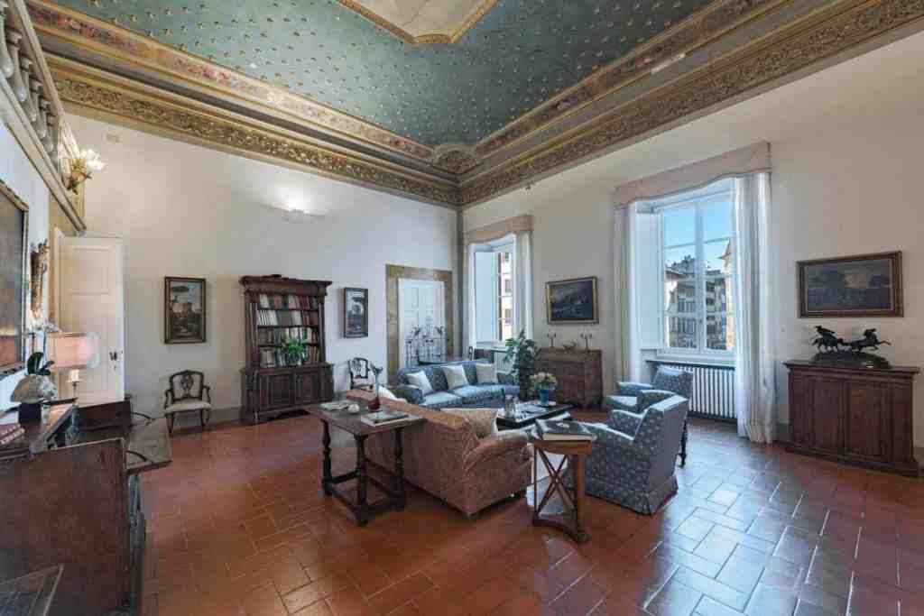 Spacious living room in a Florentine Palazzo with classic decor and high ceilings.