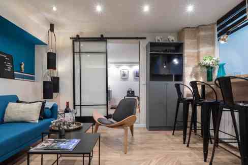 Contemporary serviced apartment living room with stylish furniture and decor.