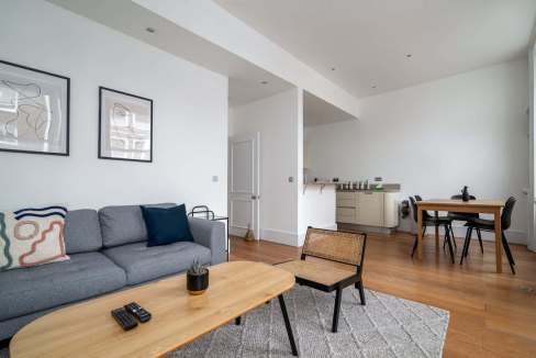 Modern living room in Kensington Culture Suite with sofa and artwork.