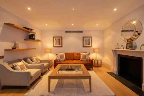 Stylish living room with modern furniture and warm lighting.