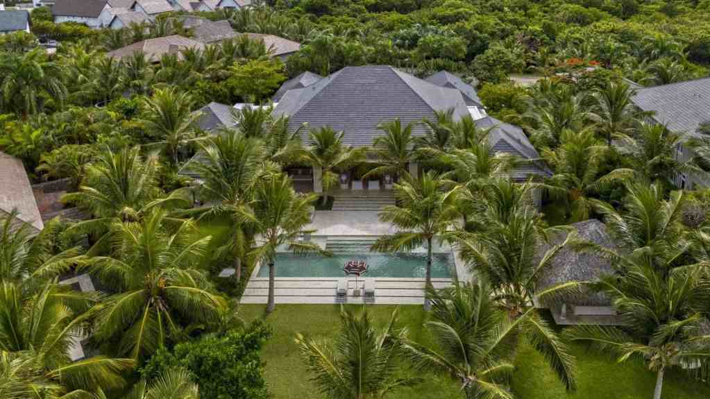 Aerial view of a tropical villa with pool surrounded by palm trees in Punta Cana.