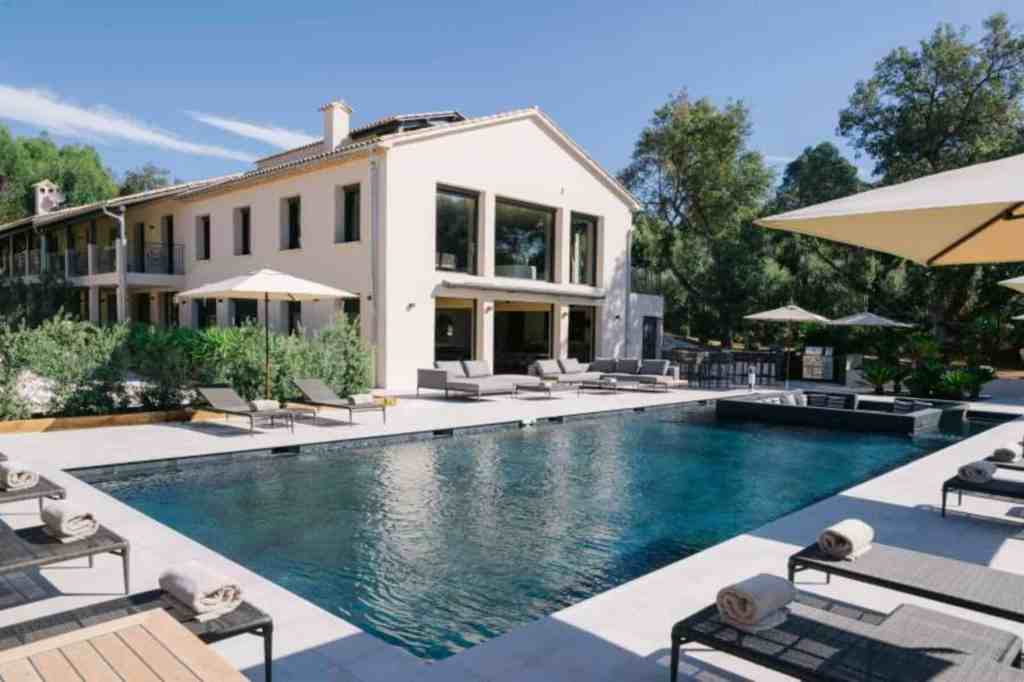 Elegant countryside serviced apartment with outdoor pool and lounge area.