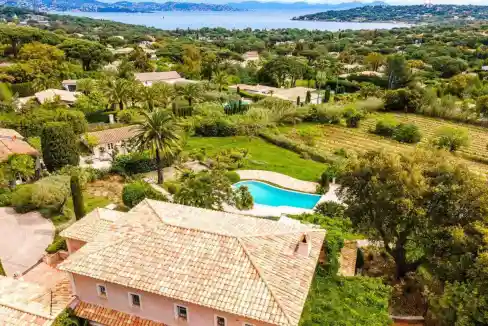 Aerial view of a Provençal villa with swimming pool and lush gardens in Saint-Tropez.
