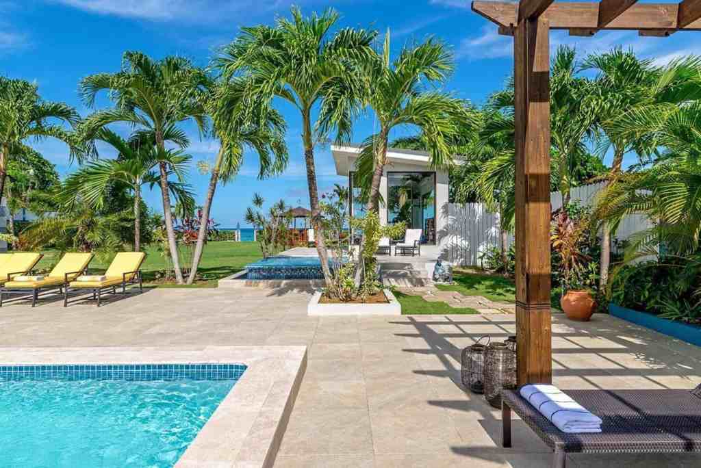 Poolside view with palm trees at Runaway Bay Luxe serviced apartment.