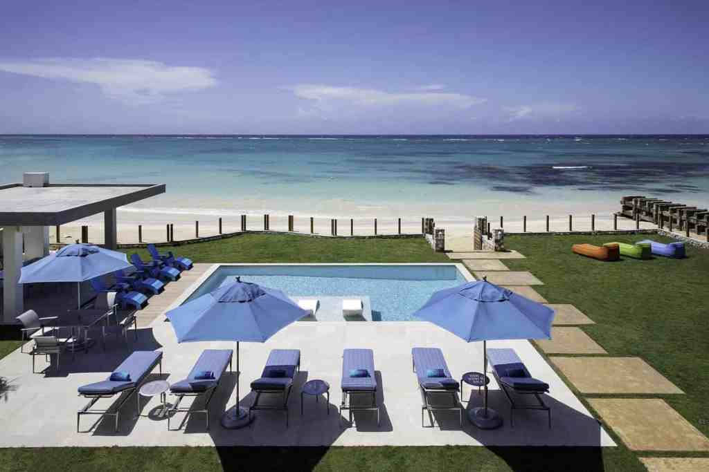 Elegant beachfront pool with sun loungers and umbrellas at Old Fort Bay Lido.