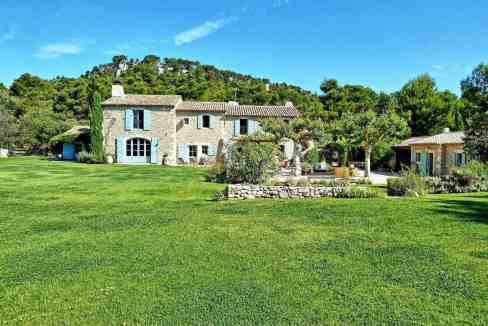 Beautiful Provençal-style estate with lush gardens and scenic hillside backdrop.
