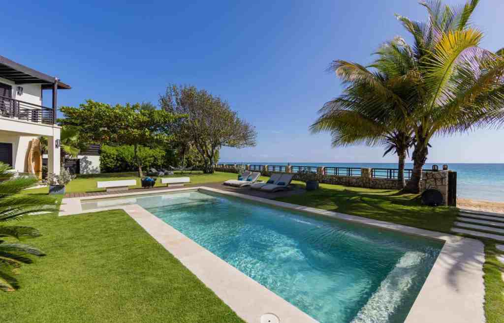 Elegant beachfront villa with private pool and tropical landscaping.