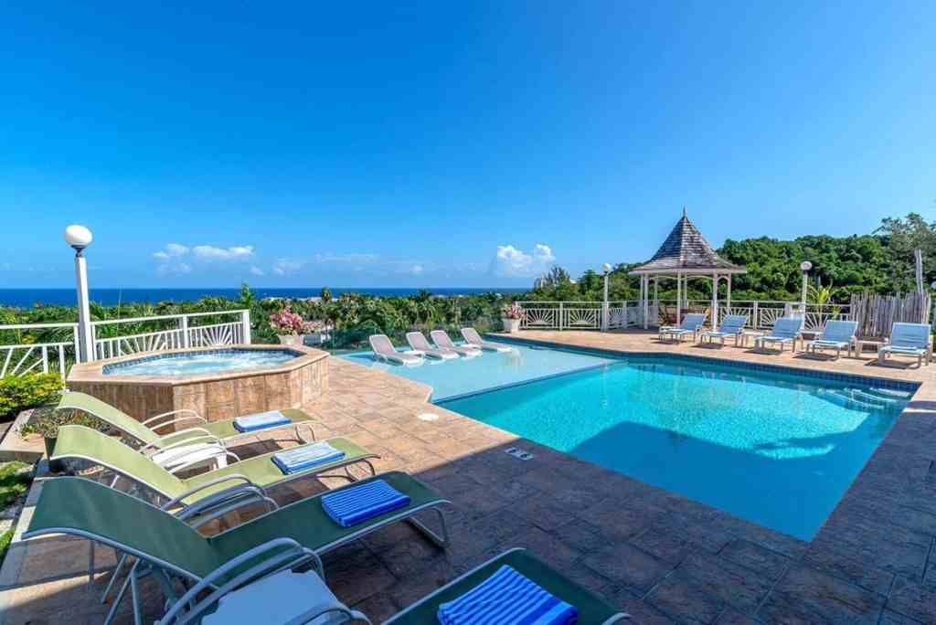 Scenic poolside view with lounge chairs and gazebo at Fairway Montego Grandeur.