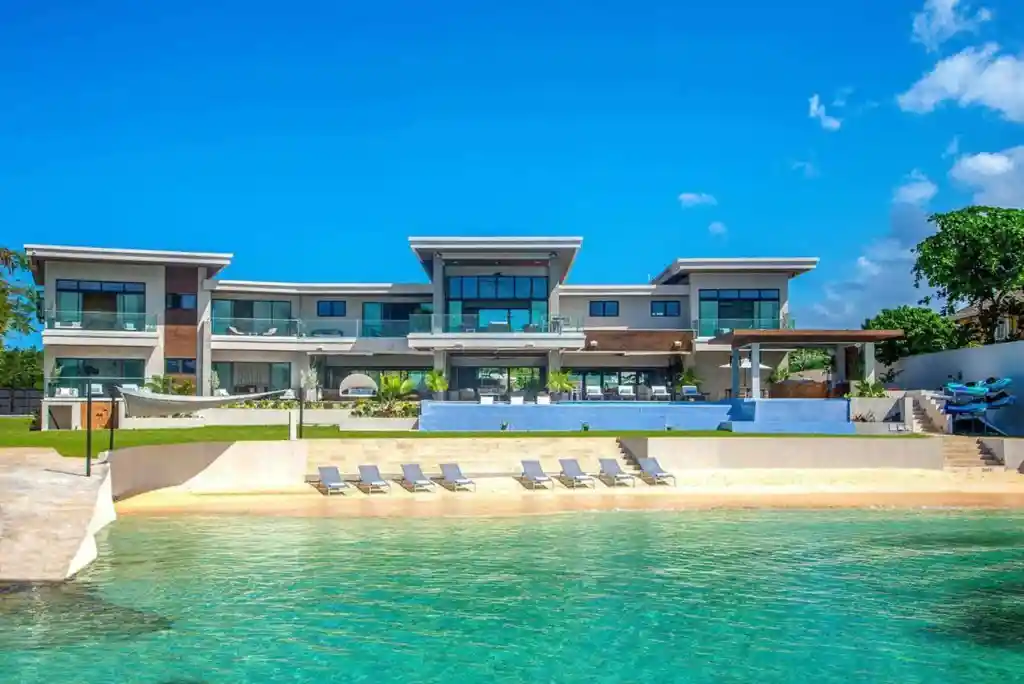 Modern beachfront villa with infinity pool and ocean view.
