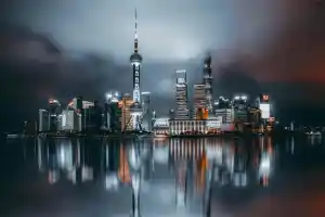 Night view of Shanghai skyline with illuminated skyscrapers and the Pearl Tower.