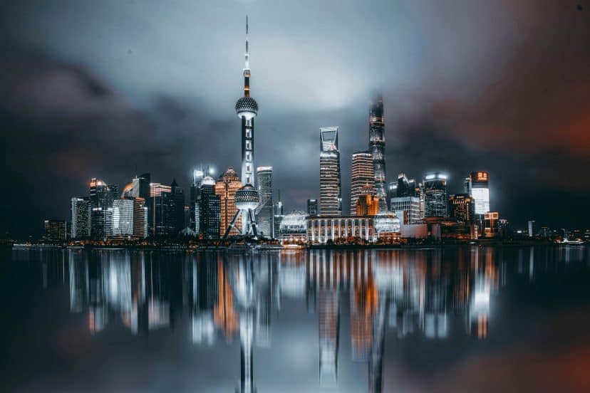 Night view of Shanghai skyline with illuminated skyscrapers and the Pearl Tower.