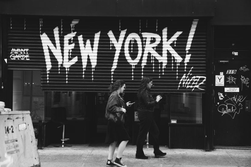 Street scene in New York with pedestrians and graffiti art.